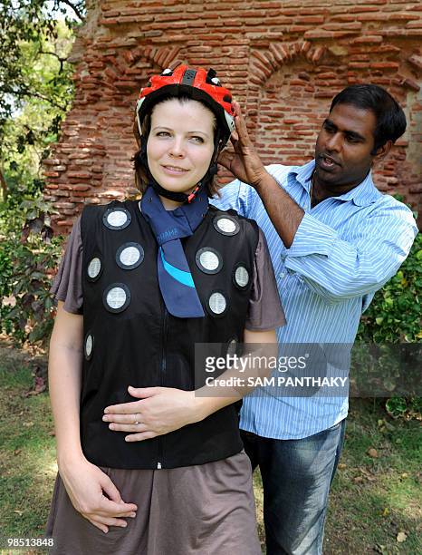 Dhama Apparel Innovations Founder and CEO Kranthi Kiran Vistakula adjusts the air conditioned "Climamet" helmet on industrial designer Julianne...