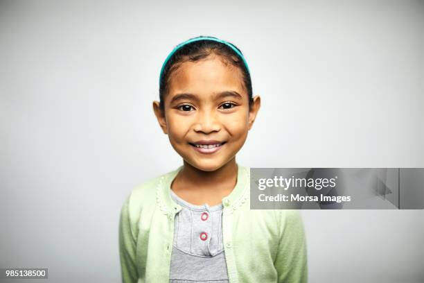 portrait of cute girl smiling on white background - child face foto e immagini stock