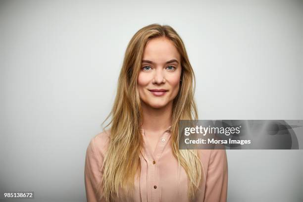 portrait of businesswoman with long blond hair - blond haar stockfoto's en -beelden