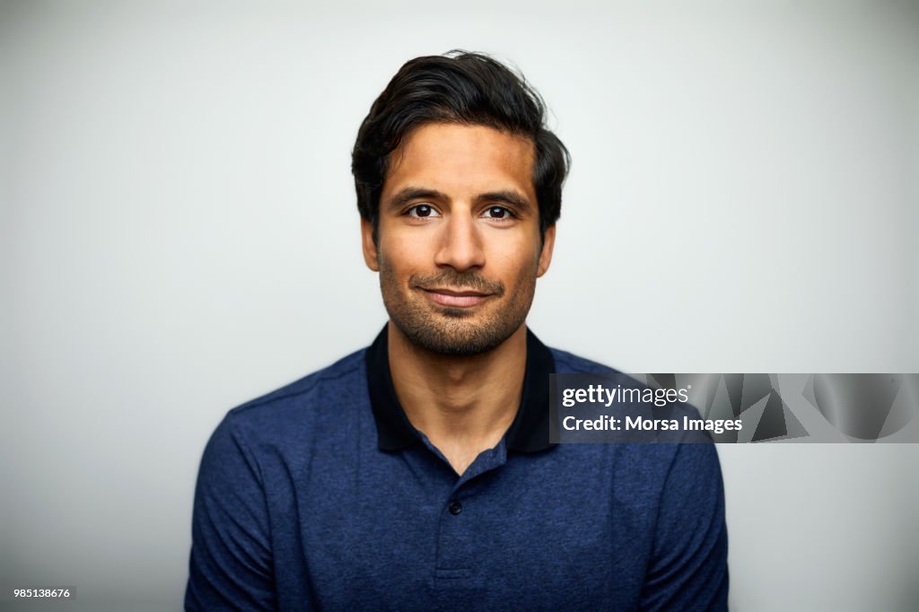 Handsome mid adult man smiling on white background
