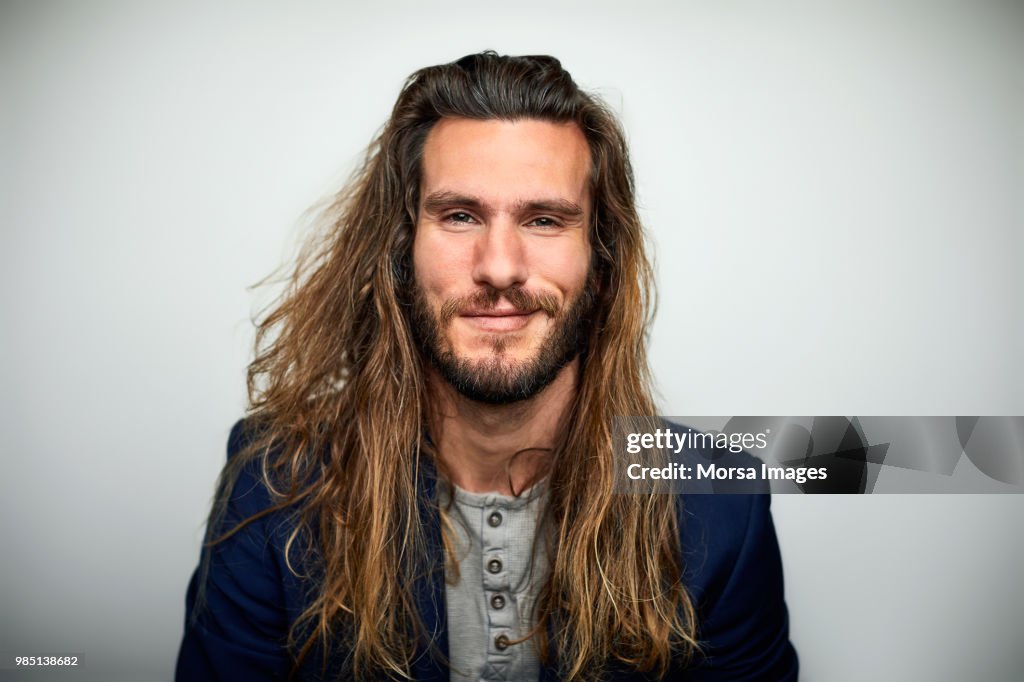 Portrait of confident man with long hair