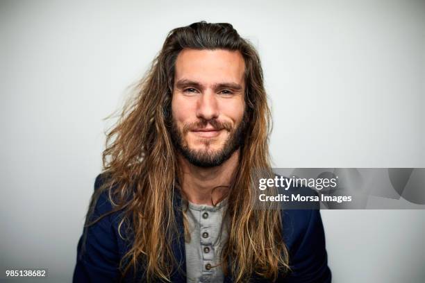 portrait of confident man with long hair - man brown hair stock pictures, royalty-free photos & images