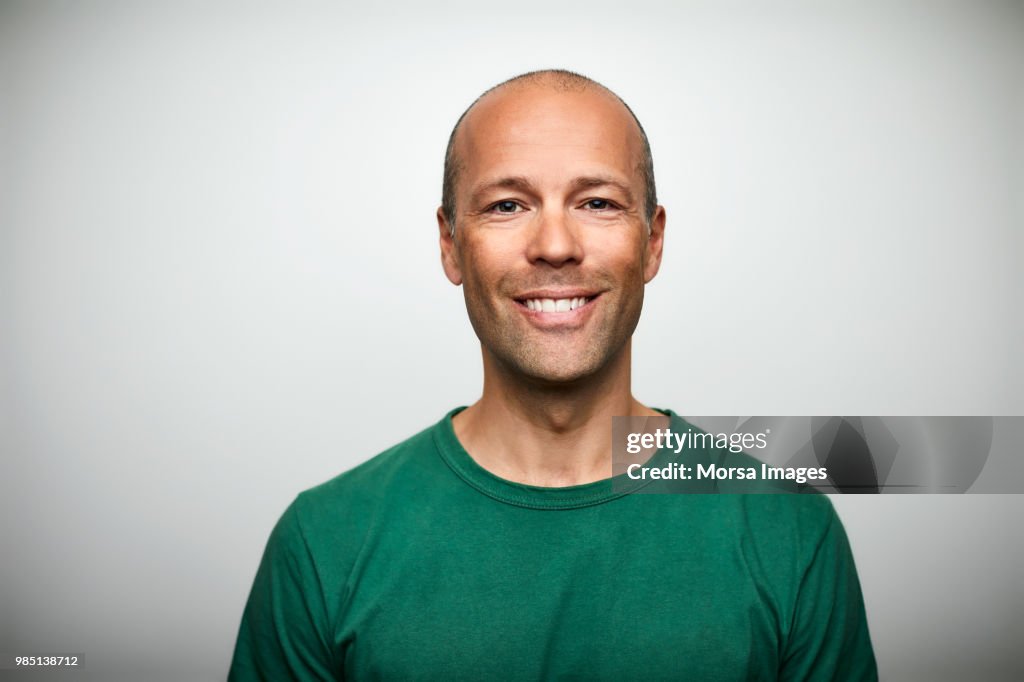 Portrait of mature man smiling on white background