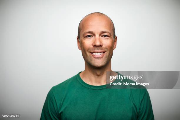 portrait of mature man smiling on white background - bald people stock pictures, royalty-free photos & images