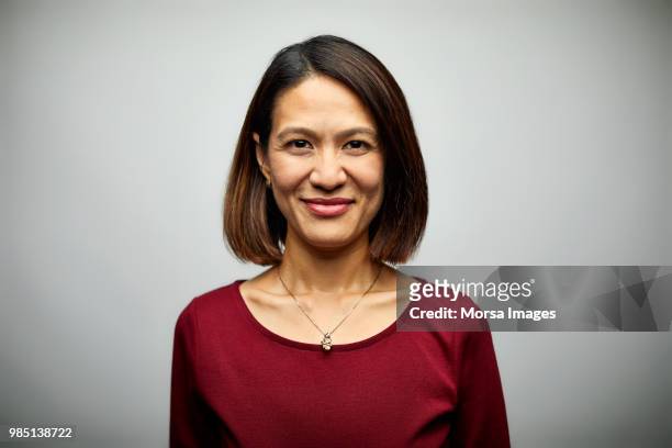 portrait of mid adult businesswoman smiling - mid adult women stock pictures, royalty-free photos & images