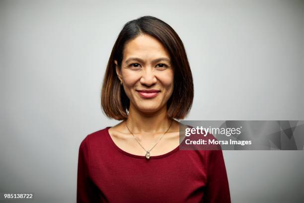 portrait of mid adult businesswoman smiling - asian woman face imagens e fotografias de stock