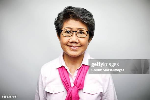 mature businesswoman smiling on white background - asia woman stock pictures, royalty-free photos & images