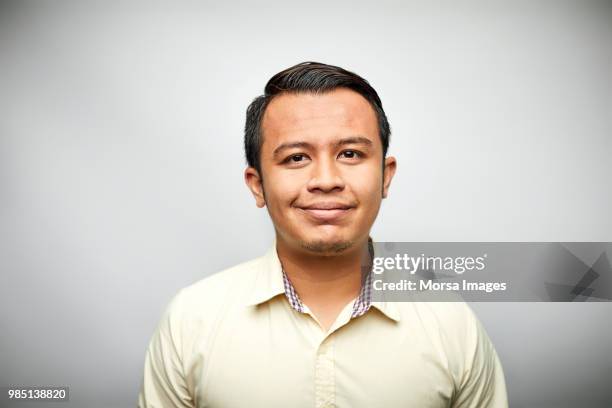 portrait of executive smiling on white background - südostasiatischer abstammung stock-fotos und bilder