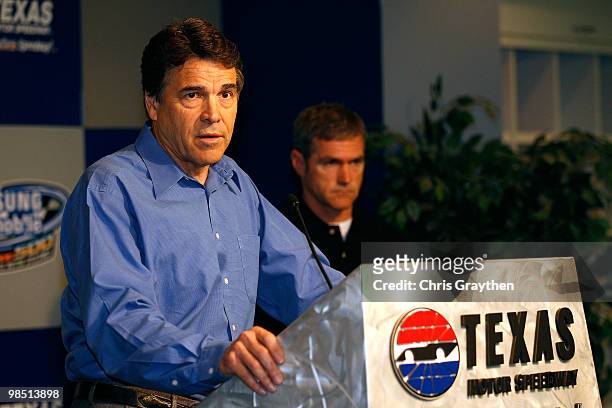 Texas Governor Rick Perry speaks to the media with NASCAR driver Bobby Labonte during a press conference at Texas Motor Speedway on April 17, 2010 in...