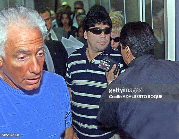Guillermo Coppola arrives with ex-soccer star Diego Armando Maradona at the Jose Marti airport in Havana 18 January 2000 for drug treatment for...