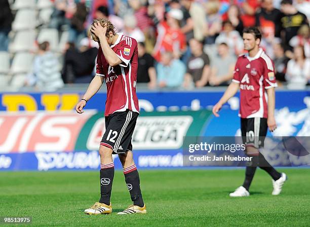 Marcel Risse and Albert Bunjaku looks dejected after the Bundesliga match between SC Freiburg and 1.FC Nuernberg at Badenova Stadium on April 17,...