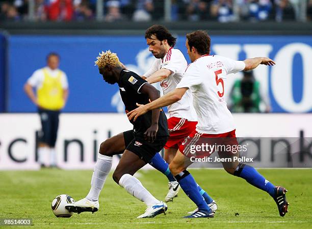 Joris Mathijsen and Ruud van Nistelrooy of Hamburg and Aristide Bance of Mainz compete for the ball during the Bundesliga match between Hamburger SV...