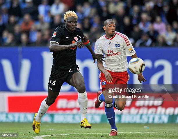 Jerome Boateng of Hamburg challenges Aristide Bance of Mainz during the Bundesliga match between Hamburger SV and FSV Mainz 05 at HSH Nordbank Arena...