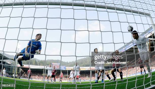 Dominic Maroh of Nuernberg scores his team's first goal while Simon Pouplin and Julian Schuster of Freiburg, Andreas Ottl of Nuernberg looks on...