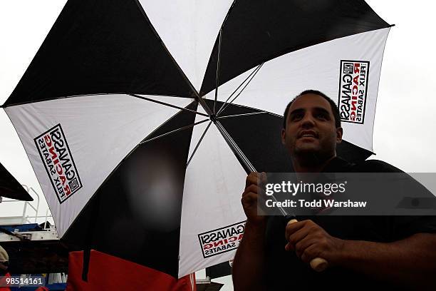 Juan Pablo Montoya, driver of the Target Chevrolet, stands in the garage area as rain delays practice for the NASCAR Sprint Cup Series Samsung Mobile...