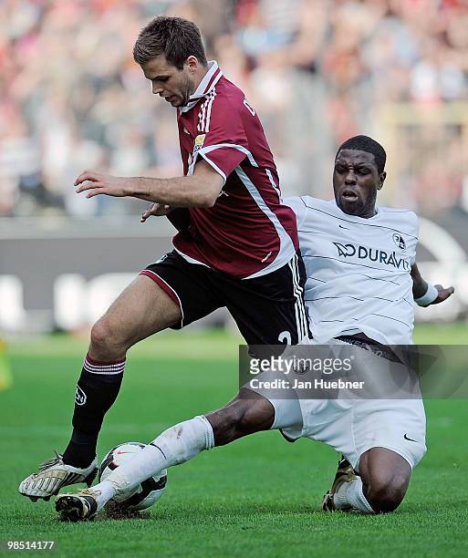 Mohamadou Idrissou of Freiburg battles for the ball with Dennis Diekmeier of Nuernberg during the Bundesliga match between SC Freiburg and 1.FC...