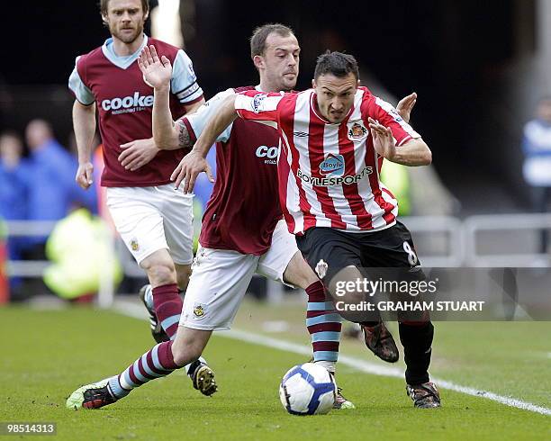 Sunderland's French midfielder Steed Malbranque vies with Burnley's Scottish striker Steven Fletcher during the English Premier League football match...