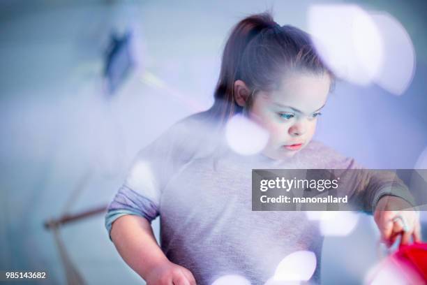 Portrait of an Authentic girl of 12 years old with Autism and Down Syndrome in daily lives