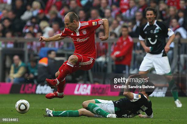 Arjen Robben of Bayern is challenged by Sergio Pinto of Hannover during the Bundesliga match between FC Bayern Muenchen and Hannover 96 at Allianz...