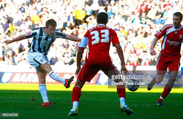 Simon Cox of West Bromwich Albion scores the opening goal past Kyle Naughton of Middlesbrough during the Coca Cola Championship match between West...