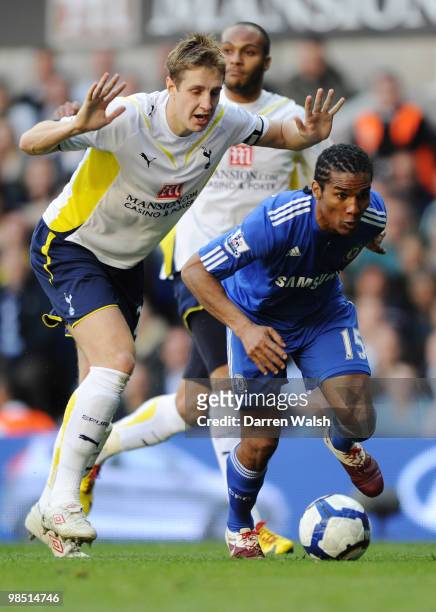 Michael Dawson of Tottenham Hotspur challenges Florent Malouda of Chelsea during the Barclays Premier League match between Tottenham Hotspur and...