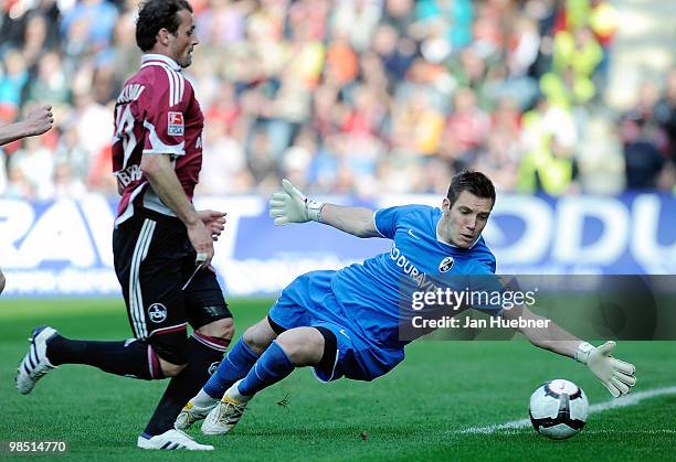 Simon Pouplin of Freiburg battles for the ball with goalkeeper Albert Bunjaku of Nuernberg during the Bundesliga match between SC Freiburg and 1.FC...