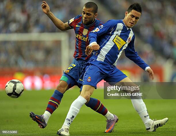 Barcelona's Brazilian defender Dani Alves vies with Espanyol's forward Jose Maria Callejon during their Spanish League football match on April 17,...