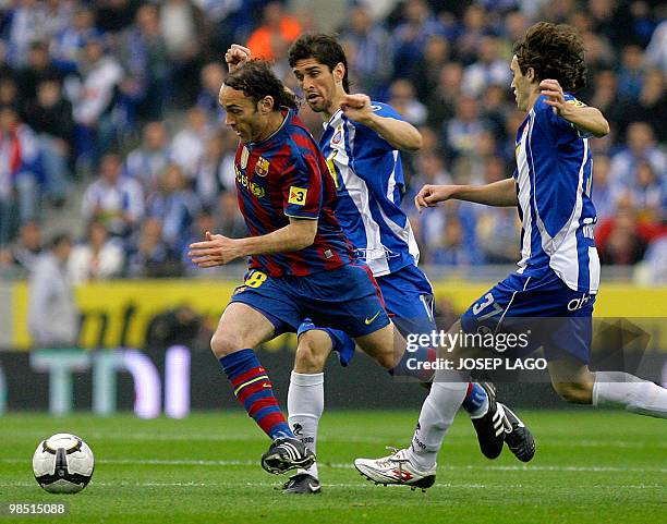 Barcelona's Argentinian defender Gabriel Milito fights for the ball with Espanyol's Argentinian defender Juan Forlin and midfielder Raul Baena during...