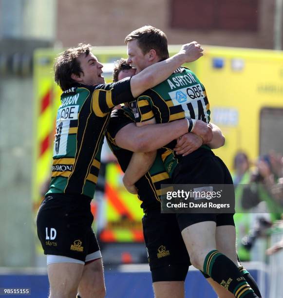 Chris Ashton of Northampton celebrates with team mates Jon Clarke and Lee Dickson after scoring his first try during the Guinness Premiership match...