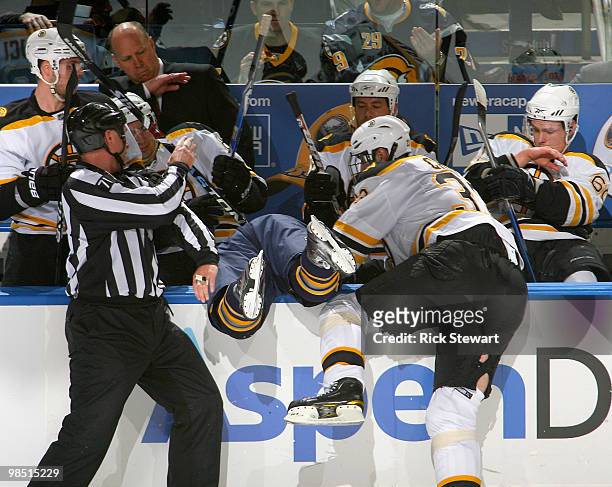Tyler Ennis of the Buffalo Sabres is checked into the Boston bench by Zdeno Chara of the Boston Bruins in Game Two of the Eastern Conference...