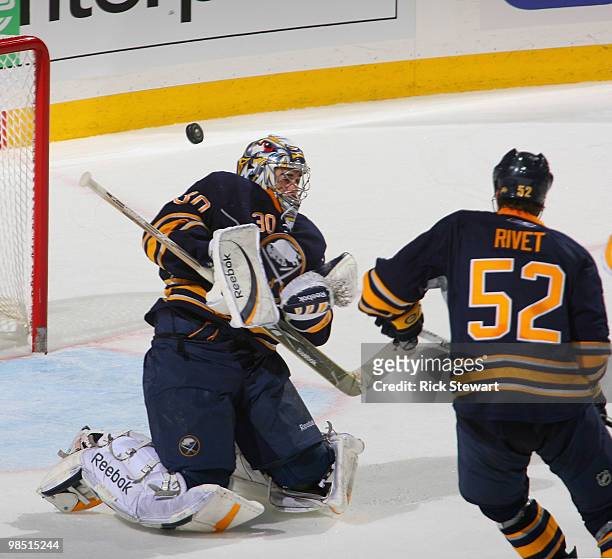 Ryan Miller of the Buffalo Sabres makes a save as Craig Rivet looks on against the Boston Bruins in Game Two of the Eastern Conference Quarterfinals...