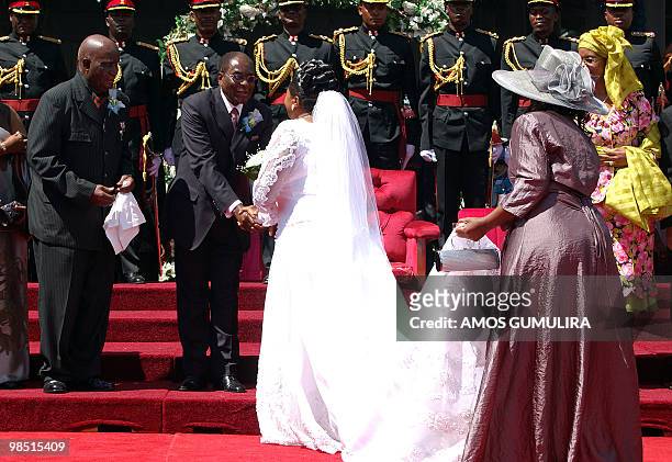 Callista Mutharika, bride of Malawian President Bingu wa Mutharika greets Zimbabwean President Robert Mugabe flanked by former Zambian President...