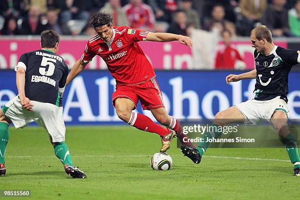 Mario Gomez of Bayern and Mario Eggimann as well as Konstantin Rausch of Hannover fight for the ball during the Bundesliga match between FC Bayern...