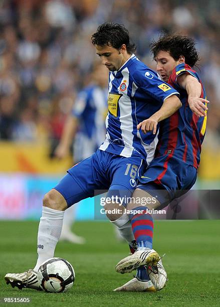 Lionel Messi of FC Barcelona duels for the ball with Nicolas Pareja of Espanyol during the La Liga match between Espanyol and Barcelona at the Nuevo...