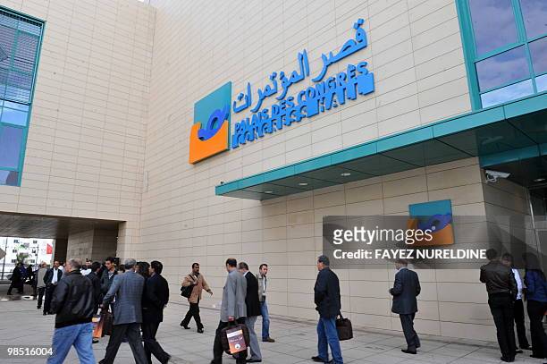 Algerian and foreigners walk by the Oran Convention Centre that hosts the Gaz Exporting Countries Forum in Oran 400kms west of Algiers on April 17,...