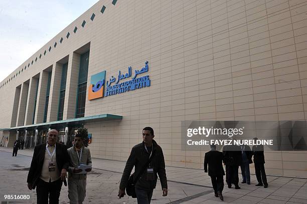 Algerian and foreigners walk by the Oran Convention Centre that hosts the Gaz Exporting Countries Forum in Oran 400kms west of Algiers on April 17,...