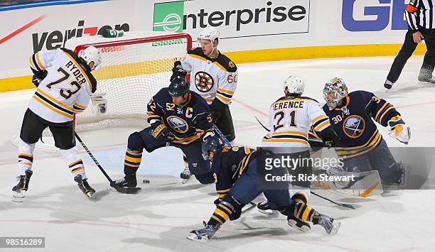 Michael Ryder of the Boston Bruins scores Boston's third goal against Craig Rivet, Jason Pominville and Ryan Miller of the Buffalo Sabres as Vladimir...
