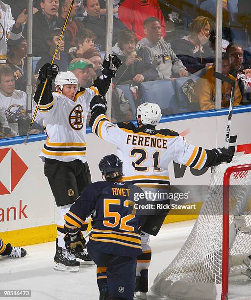 Michael Ryder and Andrew Ferrence of the Boston Bruins celebrate Ryder's second goal of the game and Boston's third goal as Craig Rivet of the...