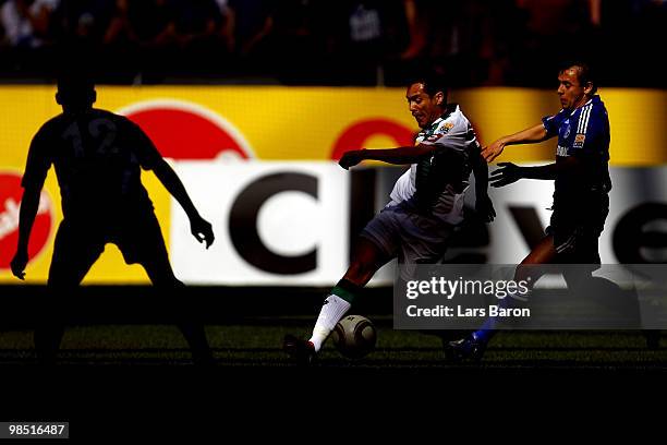 Karim Matmour of Moenchengladbach is challenged by Rafinha of Schalke during the Bundesliga match between FC Schalke 04 and Borussia Moenchengladbach...