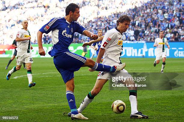 Kevin Kuranyi of Schalke is challenged by Roel Brouwers of Moenchengladbach during the Bundesliga match between FC Schalke 04 and Borussia...