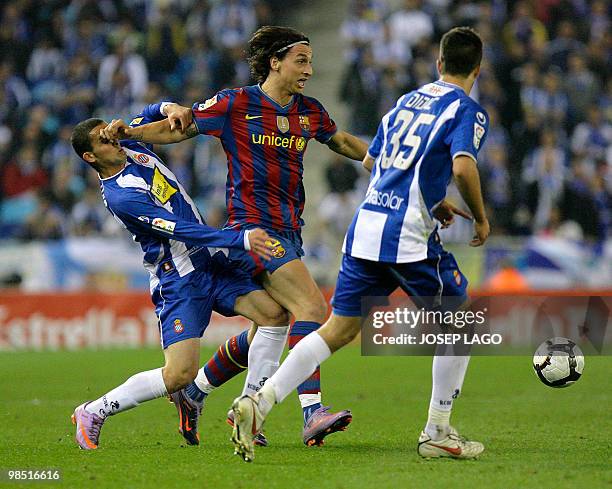 Barcelona's Swedish forward Zlatan Ibrahimovic fights for the ball with Espanyol's Israel forward Ben Sahar and defender Didac Vila during a Spanish...