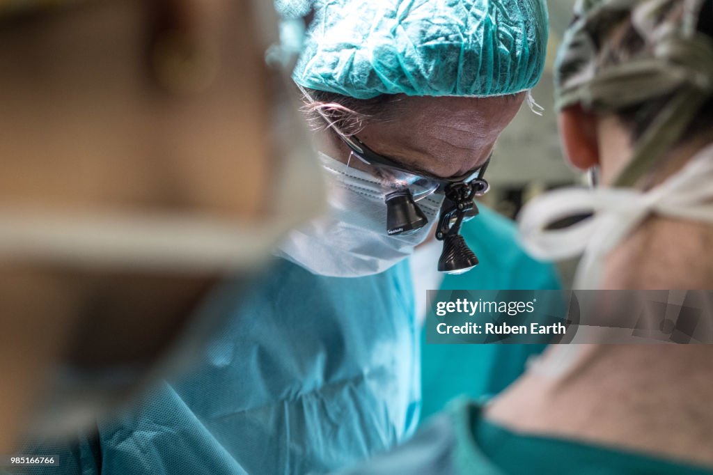 Ophthalmologist performing surgery to a patient