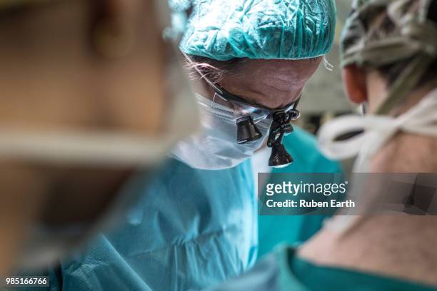 ophthalmologist performing surgery to a patient - eye doctor stock pictures, royalty-free photos & images