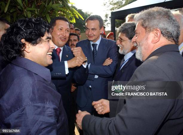 Venezuela's President Hugo Chavez jokes with Brazil's President Luiz Inacio Lula da Silva, amid Spain's Prime Minister Jose Luis Rodriguez Zapatero,...