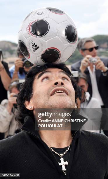 Former Argentinian football player Diego Maradona controls the ball during a photocall for Serbian director Emir Kusturica's film 'Maradona by...