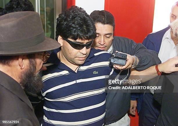 Argentine soccer legend Diego Armando Maradona is surrounded by reporters as he arrives at the Jose Marti Airport in Havana 18 January 2000. Maradona...