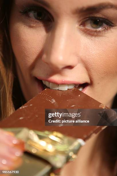 Model bites into a chocolate bar in Cologne, Germany, 26 January 2018. The International Candy Fair is open to visitors from 28 to 31 January 2018....