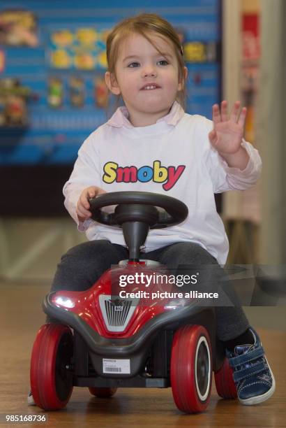 Lena rides on a toy vehicle called "Bobby-Car" by Simba Dickie during the annual press meeting of the toy manufacturers Simba Dickie and Maerklin...