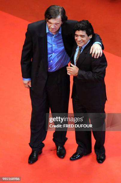 Serbian director Emir Kusturica and former Argentinian football player Diego Maradona pose as they arrive to attend the screening of their...