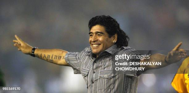 Argentina's national team coach and former football star Diego Armando Maradona gestures as he attends a felicitation programme at Salt Lake Stadium...